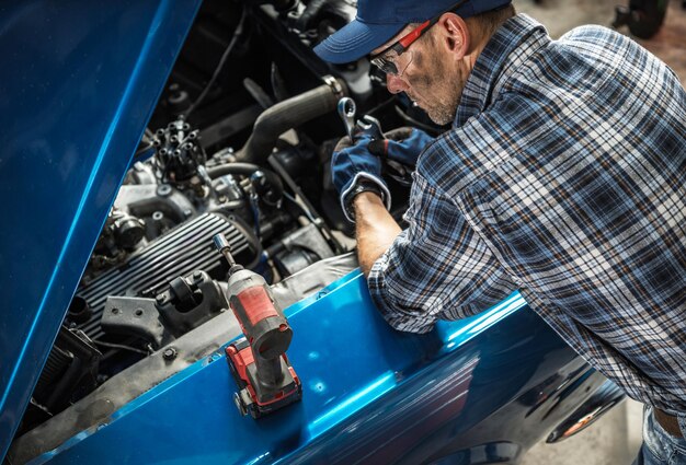 skilled-mechanic-repairs-engine-inside-workshop-afternoon